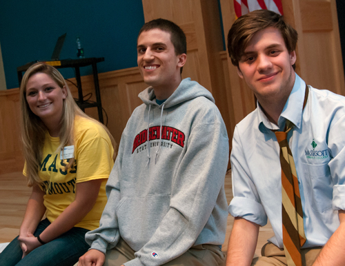 Three student speakers sitting on the stage