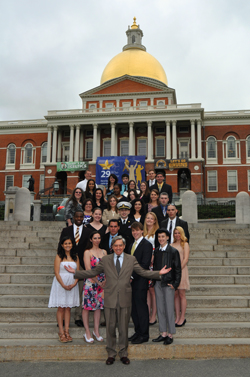 Commissioner Freeland and the "29 Who Shine" students gather in front of the Massachusetts State House