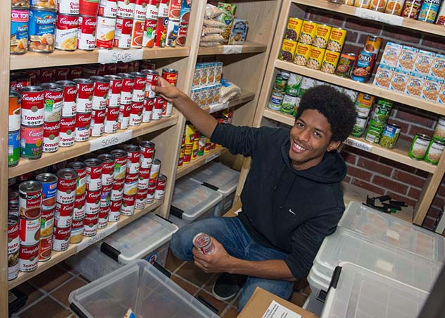 Massasoit Community College student working at a food bank