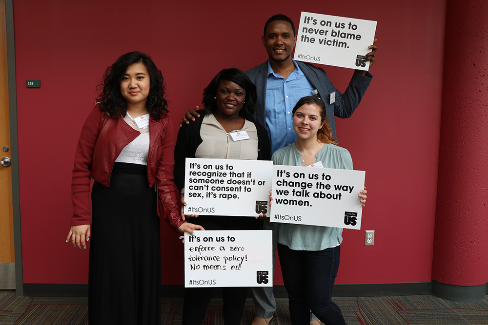 Students hold up #ItsOnUs signs at the Student Leadership Retreat in Fall 2016