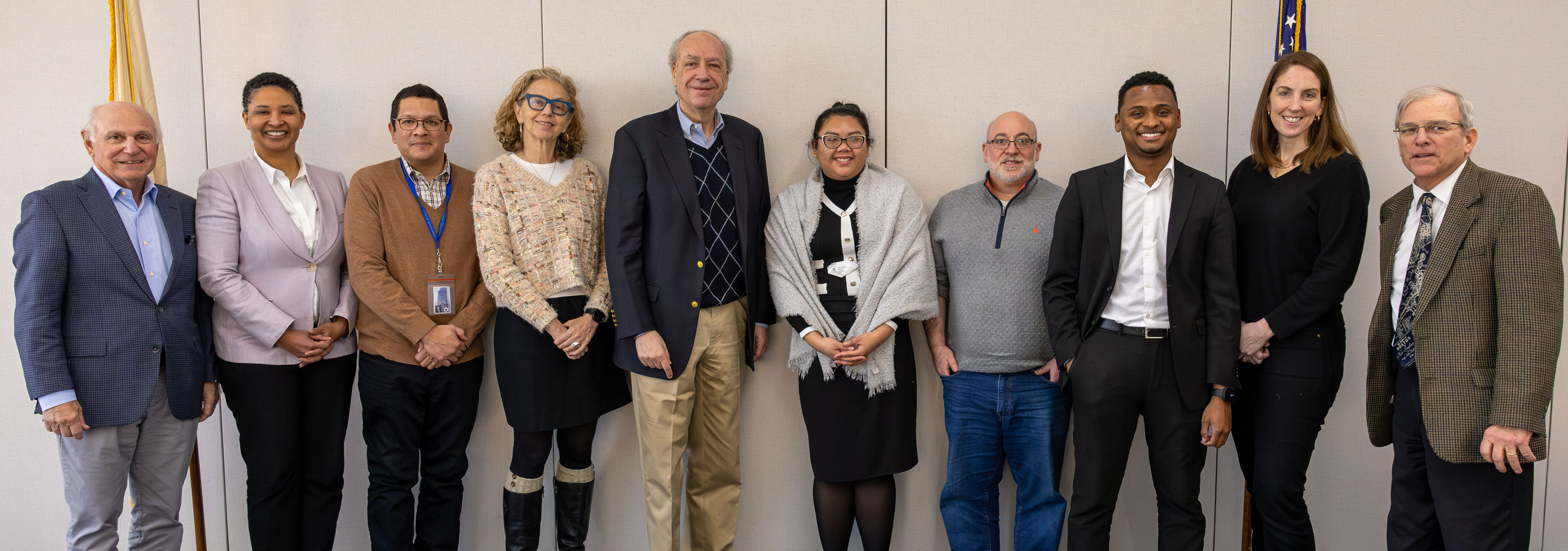 A group of board members posed formally as a group, smiling and looking directly at the camera