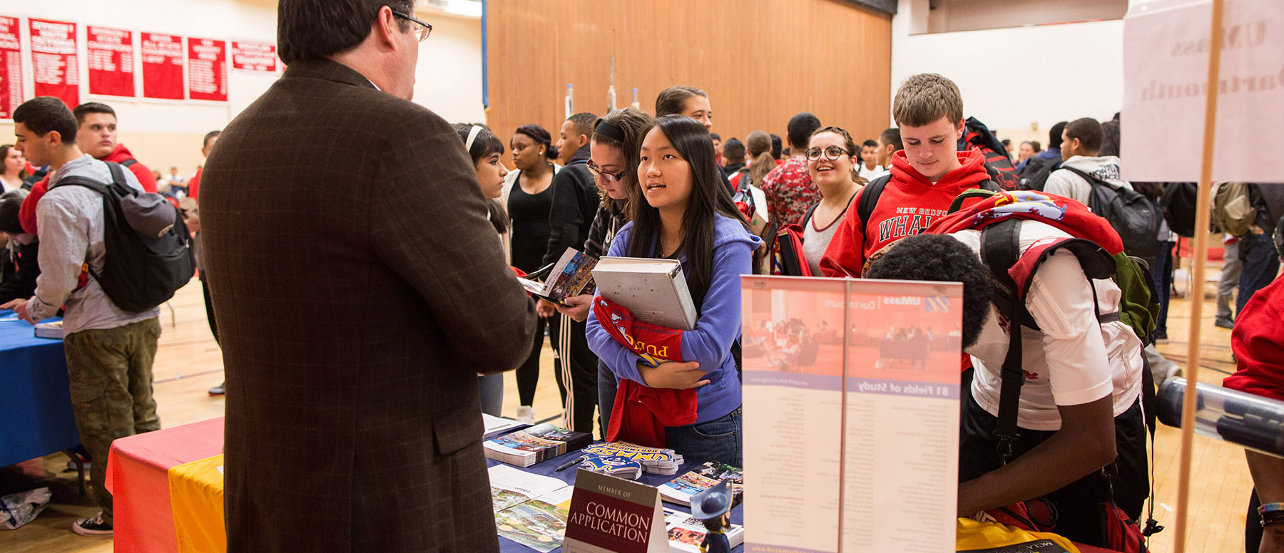 Students at New Bedford High School talk to admissions counselors at Go Higher fair in 2014