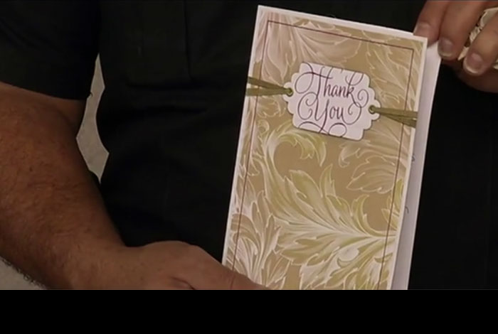 Police Officer holds thank you card from Springfield students