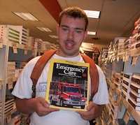 Student with emergency care book