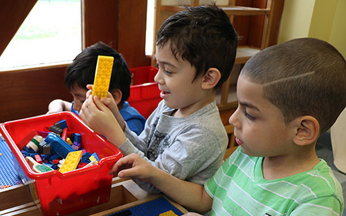 Preschool students play with blocks at the East Boston YMCA