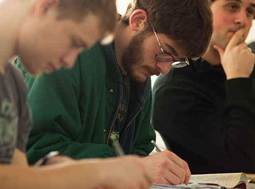 Student writes in his notebook 